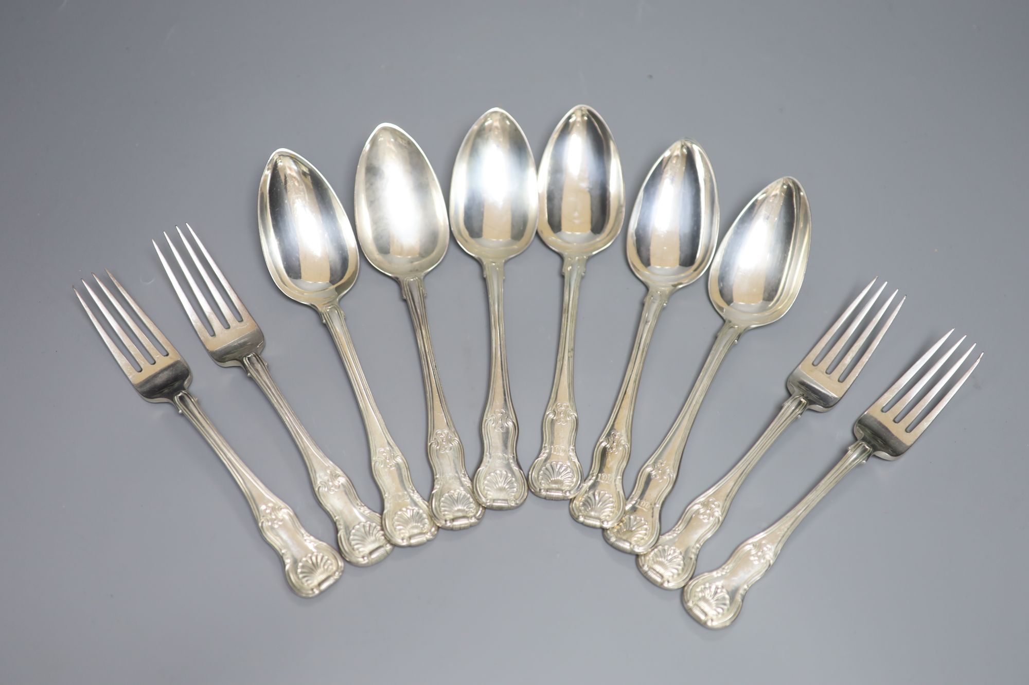 A set of six George III Irish silver hourglass pattern table spoons and four table forks, Dublin, 1813/4, Edwd. Twycross, 32oz.